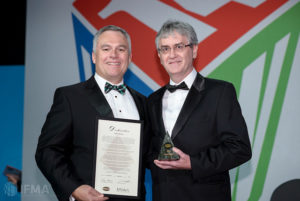Tony Keane, IFMA president, presents John McGee with his IFMA Fellowship at World Workplace 2014.