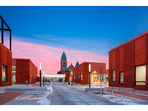 The complex fills most of two city blocks with a series of 'houses,' or classroom clusters, and related facilities whose forms and layout echo the local tradition of low-rise rowhouses surrounding interior courtyards.