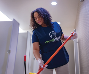 OpenWorks cleaning crews image -- employee cleaning a restroom